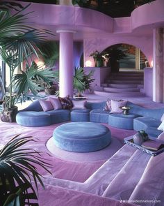 a living room filled with lots of purple furniture