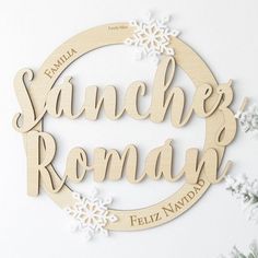 a wooden sign that says sanches roma with snowflakes around it