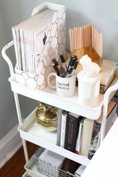 a white shelf with some books and other items on it