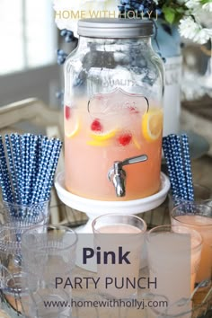 pink party punch in a mason jar with blue straws