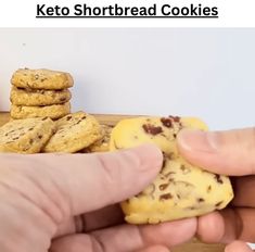 two hands holding cookies in front of each other