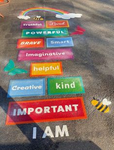 the sidewalk has been painted with different words and colors on it, including i am