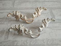 two white ornate handles on a gray background