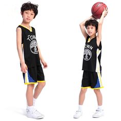 two young boys wearing basketball uniforms and holding a ball in one hand while standing next to each other