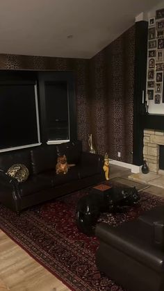 a living room with two couches and a fireplace in the corner, along with a rug on the floor