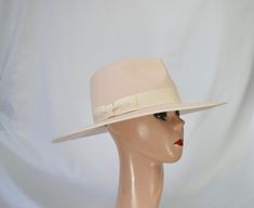 This soft pale pink color wool felt a 4-inch brim rancher style hat has a crown measurement taken from the side 4 1/2 inches, the front point of the crown is 4 1/4 inches and the back is a little under 4 inches and is one of a kind. The hat is trimmed with a soft pink grosgrain ribbon band and edges. The inside brim has a sizing cord and will fit up to 22 7/8 inch head size. This hat is one of a kind with a large brim and is not returnable. Please check the measurements before purchase. I am hap Classic Pink Wide Brim Hat, Adjustable Pink Felt Hat With Flat Brim, Artisan Pink Wide Brim Hat, Classic Pink Hat With Curved Brim, Flat Brim Pink Hat One Size, Pink Flat Brim Hat, One Size Fits Most, Pink Flat Brim Felt Hat, Pale Pink Color, Rancher Hat