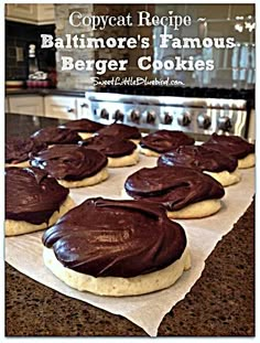 chocolate frosted cookies sitting on top of parchment paper in front of an oven with the words, copycat recipe baltimore's famous burgers famous burgerer cookies