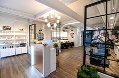 the inside of a salon with lots of counter space and mirrors on the wall above it