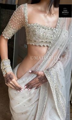 "Handmade Bridal White Embellished Saree with the hand-embellished net with cut dana and sequins, pearl, zari in flower motifs. Paired with a matching blouse. The Sari has a beautiful floral motif with hand embellishments. Blouse length can be made according to your measurements, it can be short or long. Veil is not included.. There will be slight variations in the design and handwork because it's a custom made and handmade product. Everytime handwork comes differently. Saree is custom-made. Any Indian Fashion Lehenga, Tere Naina, Embellished Saree, Off White Saree, Bridesmaid Saree, Flower Motifs