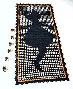 a black and white rug with an image of a person on it, surrounded by pins