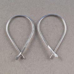 CECILE STEWART JEWELRY STERLING SILVER HOOP earrings small teardrop sleeper hammered ear wire minimal modern simple contemporary jewellery nickel free - STERLING SILVER 925 (LOW TARNISH ARGENTIUM) or GOLD FILLED - ONE INCH LONG - as pictured or choose up to 2.5 inches - FITS STANDARD PIERCINGS - STANDARD EARRING WIRE THICKNESS FOUND IN MOST EARRINGS - 20 GAUGE WIRE - hammered on one half of the earring - NICKEL FREE These earrings are handmade by me with hard temper wire to ensure they retain th Small Silver Hoop Earrings, Earring Wire, Kids Earrings, Minimal Modern, Sterling Silver Hoop Earrings, Threader Earrings, Contemporary Jewellery, Sterling Silver Hoops, Silver Hoops