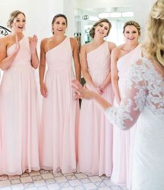 bridesmaids in pink dresses are smiling and clapping at each other's company