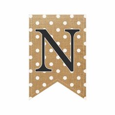 a brown and white polka dot banner with the letter n on it's side