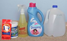 several cleaning products are sitting on the floor next to each other, including detergent and dishwasher