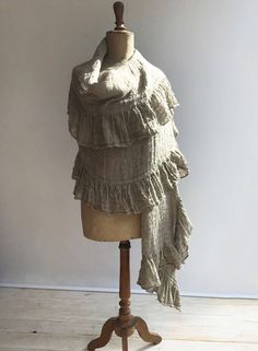 "This is a fantastic, generously sized linen shawl with an elegant ruffle along all sides. Made from gauzy, 100% pure natural taupe linen. Gorgeous texture and distinct wrinkling. Rustic texture combined with feminine styling. A great accessory that will prove itself a timeless value. The dimensions approximately 87\" x 31.5\" (220cm x 80 cm) The shawl will be pre-washed and won't shrink anymore. Care instructions: - machine washable in gentle wash cycle - preferably lukewarm water - straighten Bohemian Linen Shawl Scarf, Bohemian Linen Shawl, Beige Linen Bohemian Scarf, Bohemian Beige Linen Scarf, Linen Shawl, Shawl Wedding, Linen Scarf, Rustic Texture, Linen Scarves