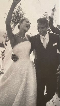 a bride and groom are celebrating with confetti