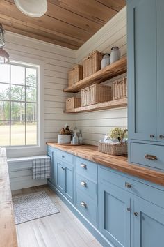 a kitchen with blue cabinets and wooden shelves