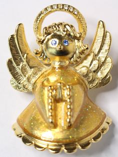 "Anne Klein Angel Pin. c. Unknown -Adorable Angel with praying hands -Glitter gold enamel dress -Matte gold finish -Rhinestones adorn halo -Blue rhinestone eyes -Signed AK -Excellent vintage condition -Measures approximately 1 3/4\" long x 1 1/4\" wide // Vintage jewelry lover? Check out my other listings for more vintage jewelry including high-end designers like Givenchy, Dior, Ciner, and KJL All jewelry purchases are tastefully wrapped in a chic gift box and adorned with ribbon - ready for gif Vintage Gold Jewelry For Holidays, Gold Holiday Brooch Jewelry, Angel Pin, Christmas Brooch, Rhinestone Eyes, Cardboard Jewelry Boxes, Praying Hands, Chic Gifts, Christmas Pins