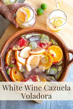 white wine cazuela volladora with oranges, limes and pomegranate