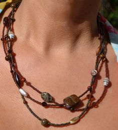 "This fun and beautiful little number is composed of browns and tans.  A gorgeous combination of varied seed beads, precious stones, shell, ceramic, cats eye, jasper beads and swarovski crystals.  It is a unique piece that is fun and versatile and sure to delight! Sterling silver trigger clasp and findings. Necklace measures approximately just over 20\" at shortest strand. Browse more from my shop here: https://www.etsy.com/shop/uniquebeadingbyme?ref=seller-platform-mcnav" Brown Double Strand Beaded Necklace For Gift, Handmade Brown Czech Glass Beads, Brown Multi-strand Beaded Necklace For Gift, Bohemian Brown Czech Glass Beaded Necklaces, Bohemian Brown Beaded Necklace With Czech Glass, Bohemian Brown Czech Glass Beaded Necklace, Multi-strand Brown Beads For Gifts, Brown Multi-strand Beads For Gift, Brown Czech Glass Beaded Necklaces With Round Beads