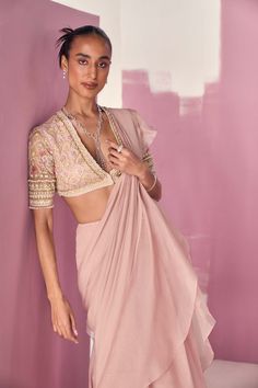 Editor's Note Elevate your style with our dusky pink net embroidered blouse, adorned with intricate embroidery on the elbow-length sleeves. Paired with a chiffon organza draped ruffled sari, this ensemble exudes grace and femininity. The soft and romantic hues of dusky pink, combined with the delicate ruffles and intricate embroidery, create a captivating look that is perfect for special occasions. The flowing drape of the sari adds an ethereal touch, while the embroidered blouse adds a touch of Saree Chiffon, Ridhi Mehra, Net Blouse, Net Blouses, Organza Blouse, Bridesmaid Inspiration, Ruffle Saree, Draped Blouse, Sharara Set