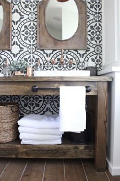 a bathroom vanity with white towels on it and a mirror over the sink in front of it