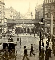 an old black and white photo of people in the street