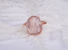 LOTUS - Raw Rose Quartz ring Candid and effortless elegance, delicate and intense at the same time. Symbol of love and beauty, Rose Quartz is the perfect gift for yourself or for your beloved half. DETAILS *Raw AAA grade Rose Quartz *Pure copper base with thick (10 micron) plating options in Silver, Gold, Rose gold. The ring you will receive will be very similar to the one showed in the photos. Though I do my very best to make them 100% identical, due to the raw nature of the stone and the total Elegant Raw Stone Gift Rings, Elegant Raw Stone Rings For Anniversary, Minimalist Rings With Raw Stone For Gift, Elegant Rings With Raw Stone, Round Shape, Elegant Raw Stone Wedding Rings, Elegant Wedding Rings With Raw Stone, Elegant Ring With Raw Stone, Promise Ring With Raw Stone Crystal Open Ring, Minimalist Crystal Ring With Natural Stones For Promise