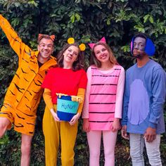 three people dressed up as winnie the pooh and tigger with one holding a bucket