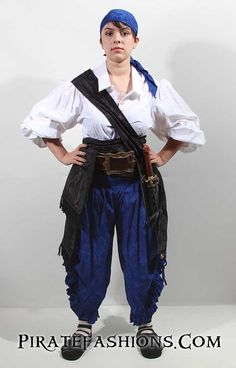 a man dressed in pirate clothing posing for a photo with his hands on his hips