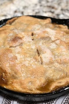 an apple pie sitting on top of a table