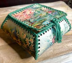 a decorative box sitting on top of a wooden table