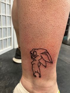 a person with a small tattoo on their leg that has an image of a dog