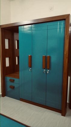 a blue cabinet with two doors and drawers