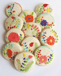 some decorated cookies on top of each other with different colors and designs in the middle