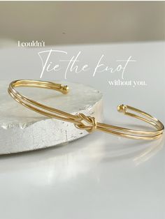 Knot Love Bracelet  - Endlessly Tied, Infinitely Loved.  Ideal for brides expressing gratitude to their bridesmaids, this bracelet, crafted from exquisite 18k gold-filled material, showcases a delicate love knot on a cuff style bracelet. Symbolizing enduring bonds, it makes a meaningful gift for brides to present to their mothers, beautifully encapsulating the concept of an everlasting connection on such a special occasion D E T A I L S - 18K Gold Filled Dainty Bangle Bracelet  - Adjustable  - Each individually packaged in signature microfiber pouch for easy gift giving  - 3mm thickness (dainty)  P A C K A G I N G Dylan Rae Jewelry is elegantly presented in our premium microfiber jewelry case, ensuring both protection and a polished presentation.  C A R E Care for Your Gold Filled Jewelry: Bracelet Tie, Gold Knot Bracelet, Mother Daughter Gifts, Perfect Wedding Gift, Knot Bracelet, Tie The Knot, Wedding Jewelry Bracelets, Friendship Gifts, Bridesmaid Proposal