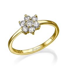 a yellow gold ring with three diamonds