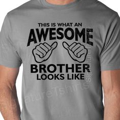 a man wearing a grey t - shirt with black lettering that says, this is what an awesome brother looks like