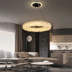 a living room filled with furniture and a chandelier hanging over the top of it