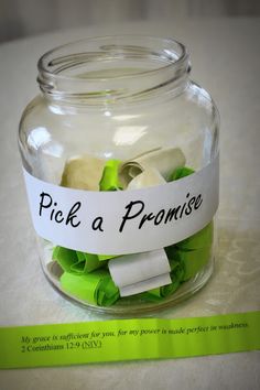 a glass jar filled with green and white paper