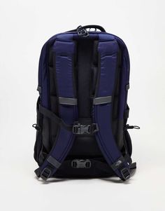 the back view of a blue backpack on a white background