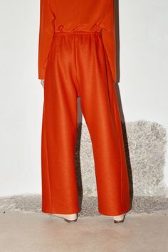 Oversized Pants Pants are fitted to waist or hips with an elastic comfortable band Adjustable wool band in the inside waist Triangular piece on sides Inseam pockets French seaming Colour: Lava (Red Orange) One size fits all. Model is 177cm /5 '9" 100% Alpaca Wool (Italy)MADE IN SPAIN Fall Season Wide Leg Trousers, Solid Wool Tapered Leg Pants, Wool Wide Leg Pants For Loungewear, Wool Ankle-length Pants With Pockets, Ankle-length Wool Pants With Pockets, Oversized Wide-leg Winter Pants, Oversized Wide-leg Pants For Winter, Orange Wide-leg Pants For Fall, High-waisted Wide Leg Orange Pants For Fall