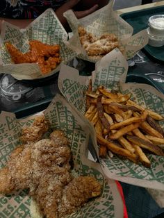 fried chicken and french fries are sitting on trays