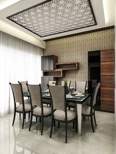 a dining room with a glass table surrounded by beige chairs and upholstered walls