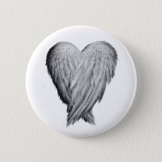 a white button with black wings on it