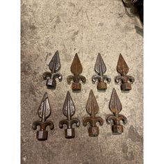 six metal florets are sitting on the ground