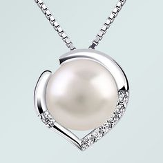 This 7-8 mm freshwater cultured pearl is set in a peach shaped heart. It is surrounded by AAA cubic zircons. This pearl pendant comes with a Italy 925 sterling silver chain. It is a perfect gift for Mother's Day, Valentine's Day, Christmas and Birthdays. Item is enlarged to show details.  Colors may not always be exact because of light refraction and/or camera angle from which the picture was taken.  Specifications: Main Metal Type925 Sterling Silver Main Stone 1Freshwater Pearl Main Stone 2White CZ Chain TypeItaly 925 Sterling Silver Box Chain Chain Length (Inches)16 in  + 2 in extension Chain Length (Centimeters)40 cm + 5 cm extension Clasp TypeSpring Clasp Plating MetalRhodium Pendant Size (Inches)0.47 in x 0.47 in Pendant Size (Centimeters)1.2 cm x 1.2 cm FeatureNickel Free, Lead Free Glendale Az, Pearl Heart, Silver Box, Dec 12, 925 Sterling Silver Chain, Box Chain, Pearl Pendant, Mother Day Gifts, Sterling Silber