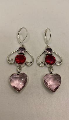 Vintage rose quartz hearts sterling silver lever back dangle earrings Set with antique ruby glass and amethyst Delicate and detailed vintage pale pink color Rose Quartz gemstone Sterling Silver lever back earrings These dangle earrings are over 1 in long All jewelry is shipped in a nice gift box. Check out our over a THOUSAND great reviews Can be converted to Clip on earrings add request Pink Heart-shaped Gemstone Earrings, Pink Heart Gemstone Earrings, Pink Gemstone Earrings For Valentine's Day, Pink Round Heart Earrings, Silver Gemstone Heart Earrings For Valentine's Day, Valentine's Day Silver Heart Earrings With Gemstone, Valentine's Day Silver Heart Gemstone Earrings, Rose Quartz Heart, Peridot Stone