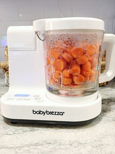 a blender filled with lots of carrots on top of a counter