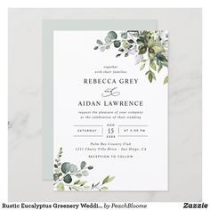 an elegant wedding card with greenery on the front and bottom, in white paper